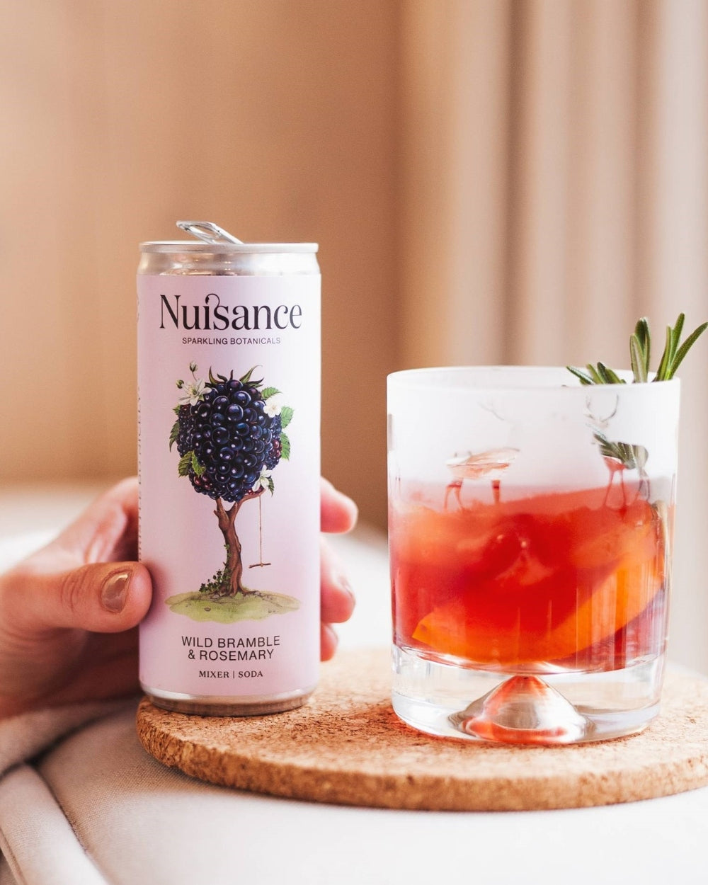 A cold refreshing glass of sloe gin is topped with a refreshing can of premium Bramble and Rosemary botanical soft drink from Scotland-based drinks start-up brand Nuisance drinks making the perfect winter warmer
