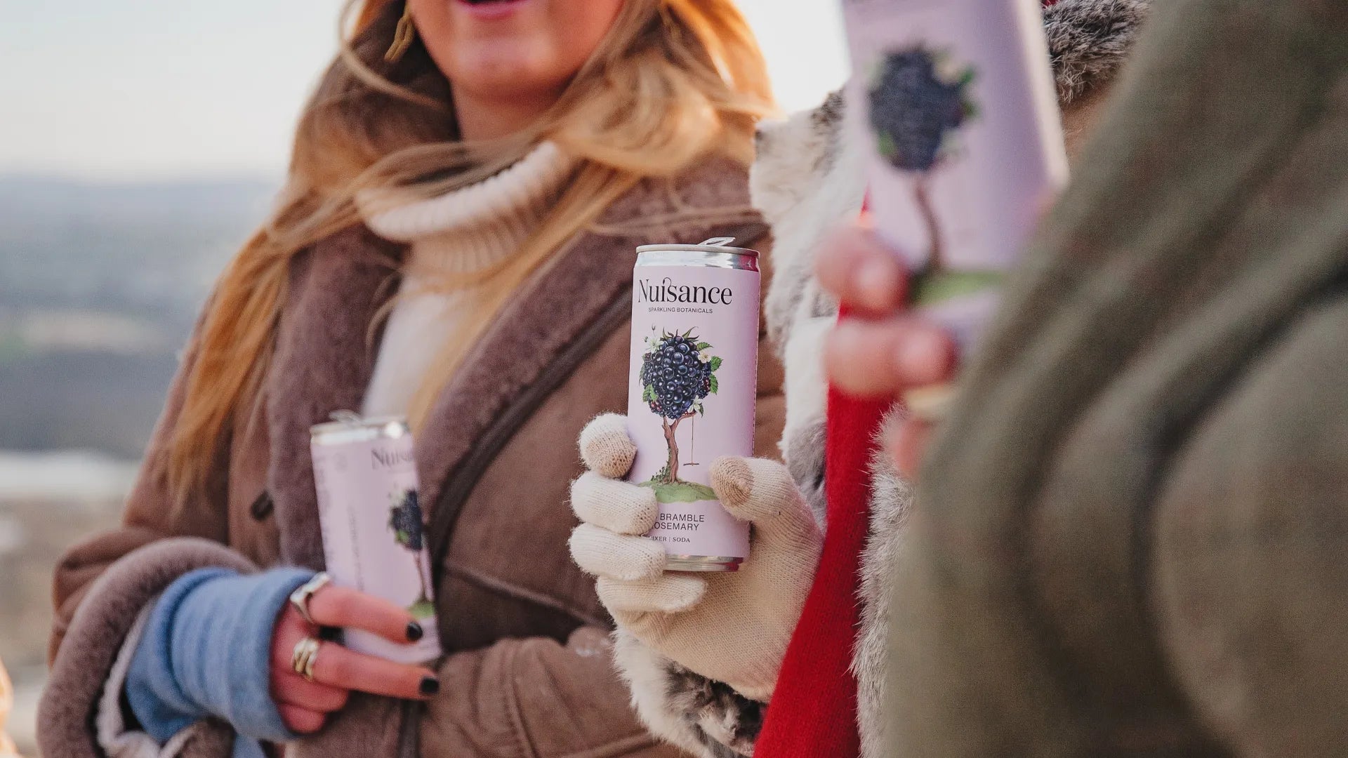 Image of a patrons enjoying  Nuisance  premium bramble and rosemary botanical soft drink