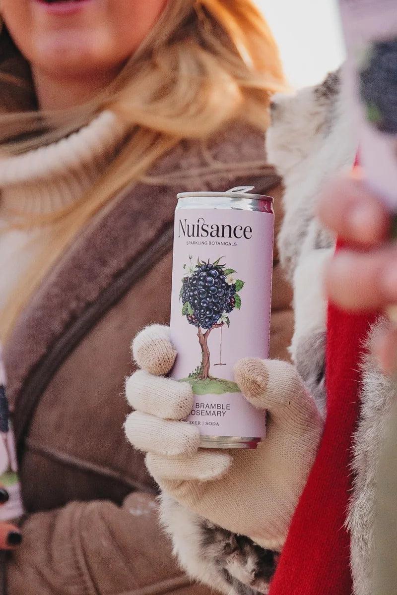 Image of a patrons enjoying  Nuisance  premium bramble and rosemary botanical soft drink