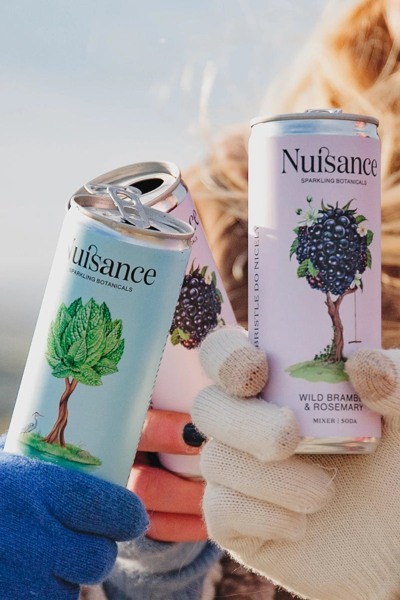 Patrons toasting with a selection of Nuisance premium botanical soft drinks