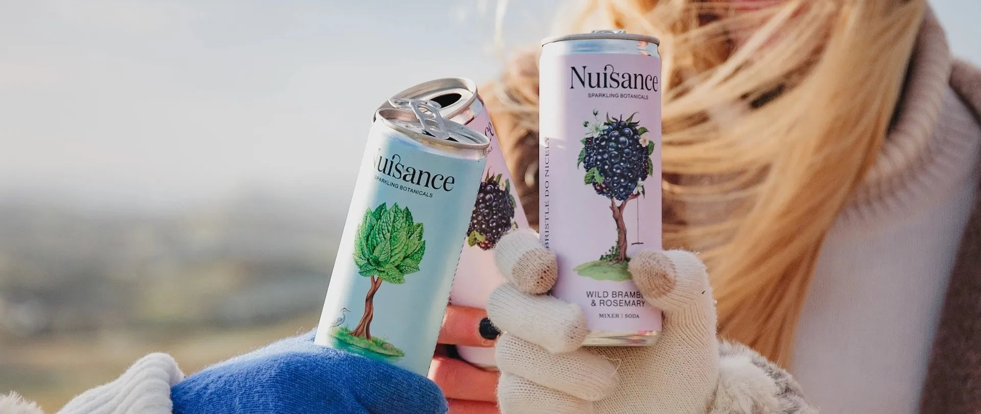 Patrons toasting with a selection of Nuisance premium botanical soft drinks