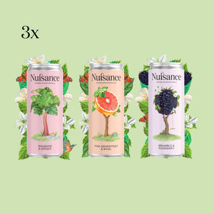 Three cans of Nuisance drinks with colourful labels on a light green background