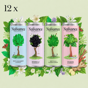 4 nuisance drinks cans on green background 